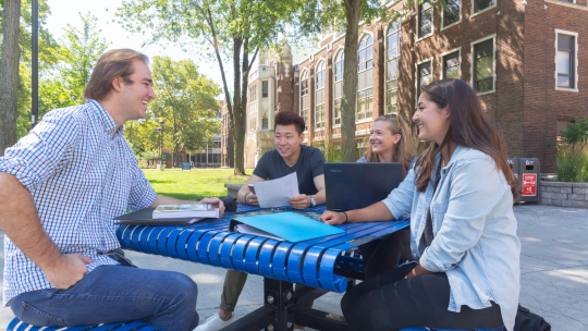 Students on campus working together outside